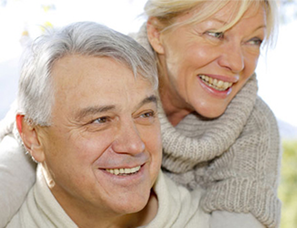 Senior couple smiling and embracing
